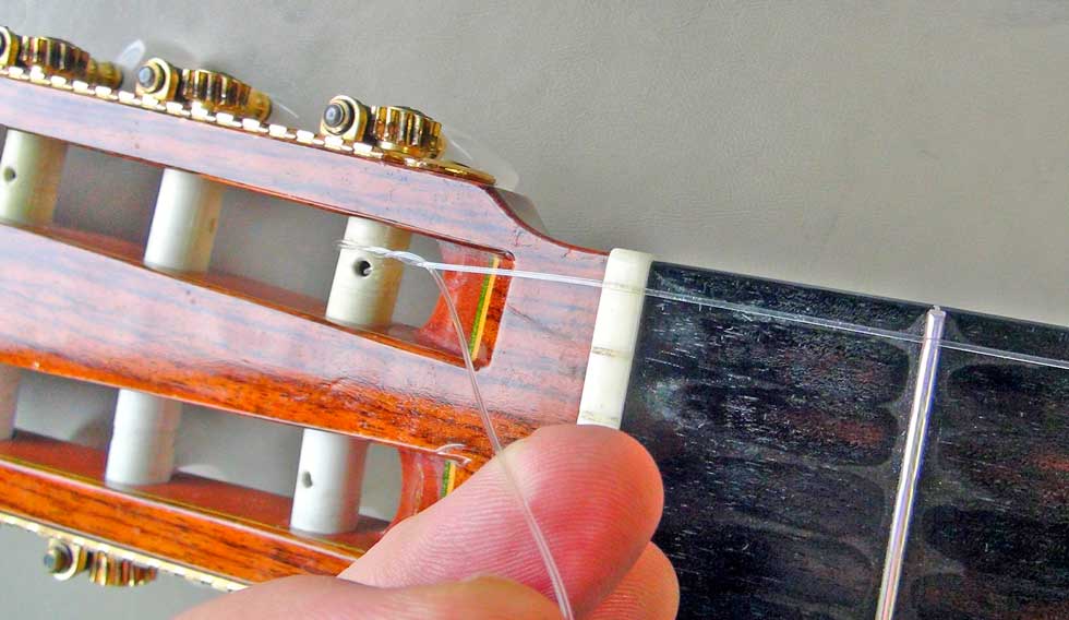Place the First String in the Correct Slot In the Nut