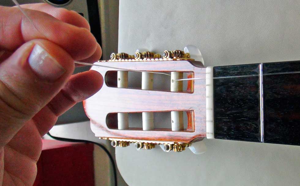 Pass the First String Through and Over the Top To the Front