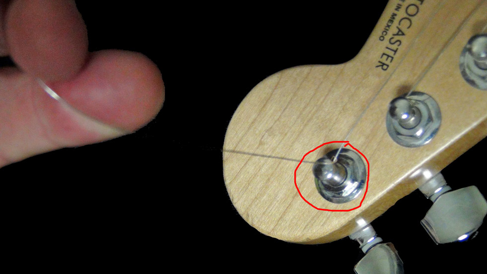 Pull the string out and away from the guitar as you tighten it